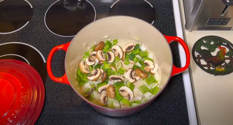 Place your pot or pan on medium heat and add olive oil along with the onions, celery, green peppers, and mushrooms. Sprinkle with salt and pepper and cook until the onions are translucent.